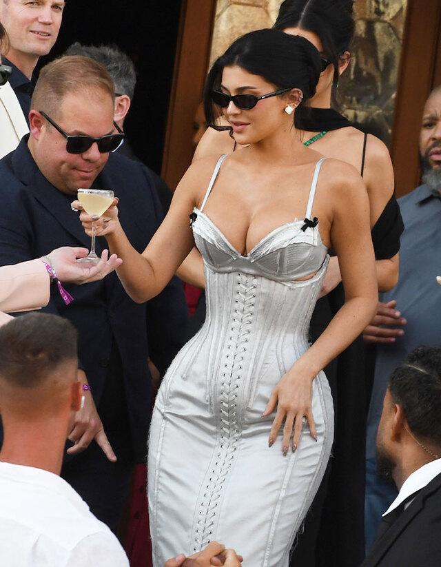 Kylie Jenner arrived at the star-studded wedding celebration in Venice in a corseted, strappy gown that shimmered in silvery blue