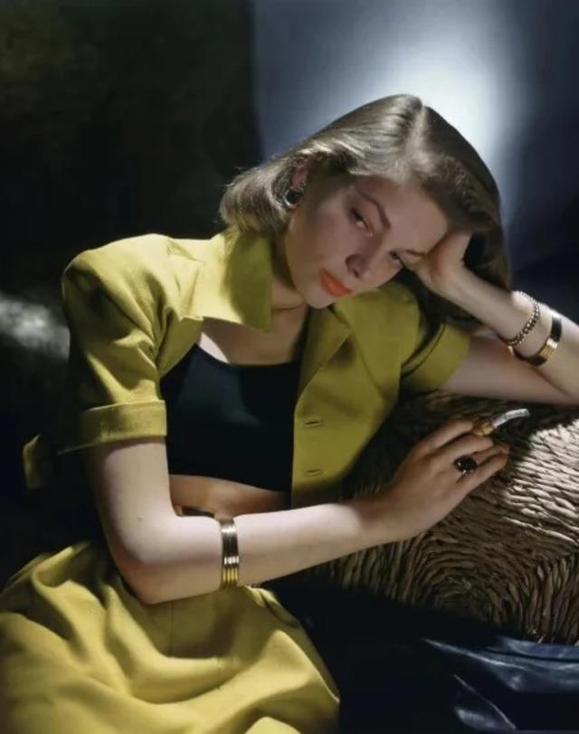 Lauren Bacall in an iconic film pose, showcasing her distinctive style and commanding screen presence.