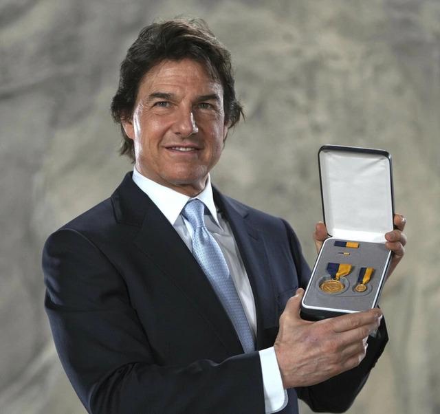 Tom proudly displays his prestigious U.S. Navy award, yet the spotlight remains firmly on his noticeably altered look.