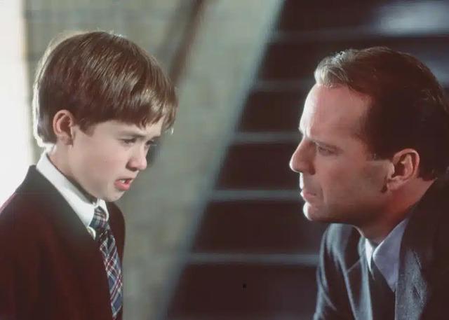 A defining moment from The Sixth Sense—Haley Joel Osment as Cole Sear, sharing a pivotal scene with Bruce Willis.