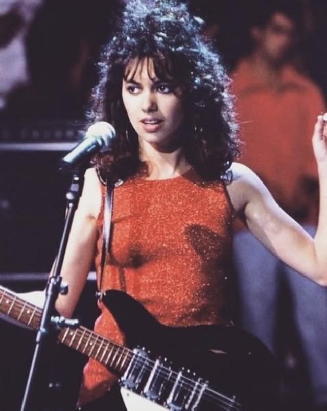 A radiant moment from her early solo era: Hoffs performing with a captivating gaze and her unmistakable, emotive voice.