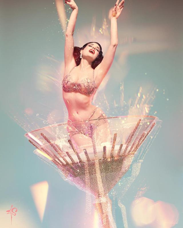 Dita Von Teese in her iconic martini glass, a visual feast of sparkling crystals and elegance in motion.
