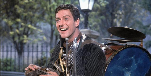 In Walt Disney’s Mary Poppins (1964), he played Bert, the chimney sweep whose tap-dancing rooftop number remains one of cinema’s most joyful sequences.