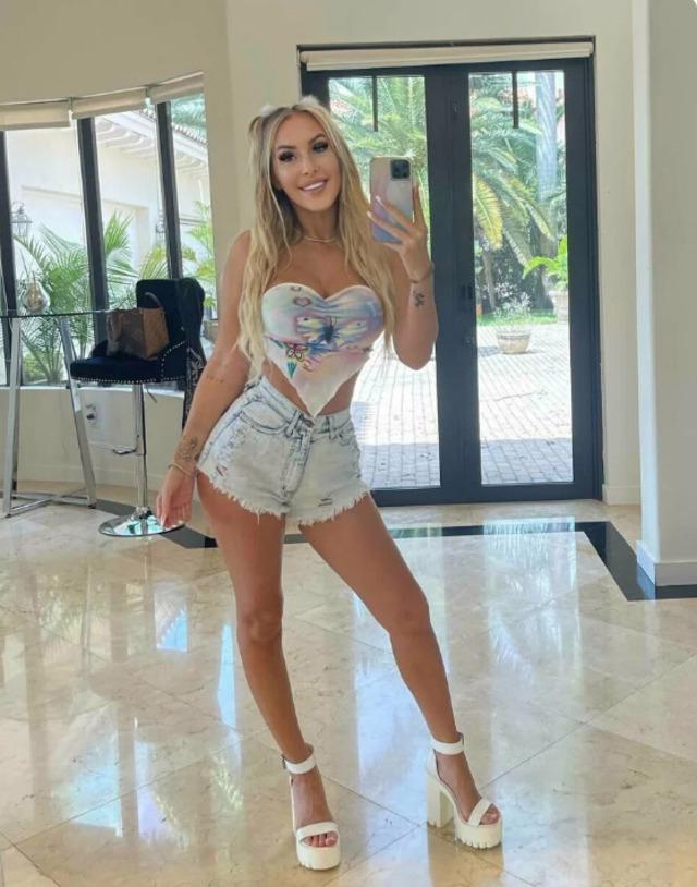 Jessika Gotti embraces summer vibes in a floral wrap top and light denim shorts.