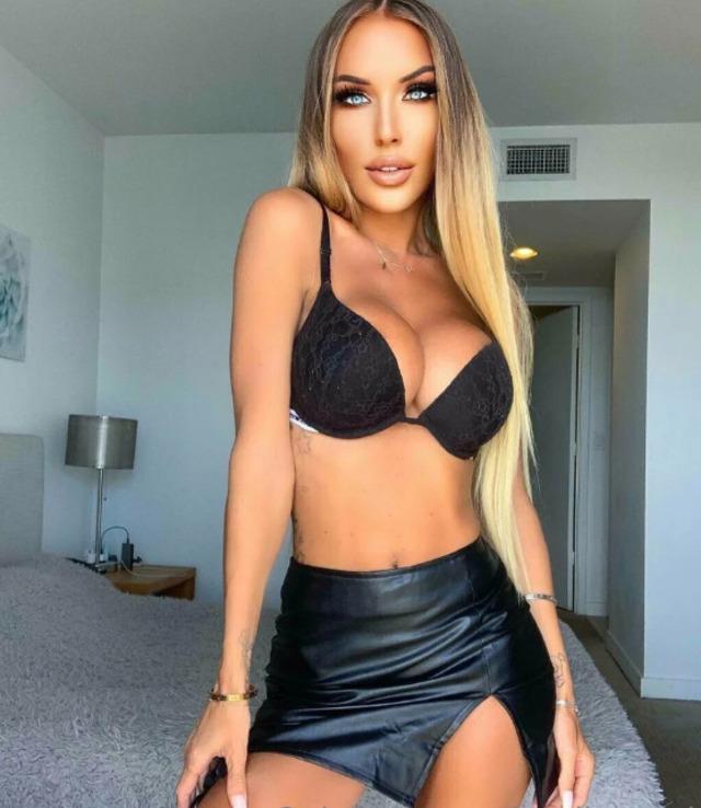 Jessika Gotti exudes confidence and allure in a black bra paired with a sleek leather skirt.