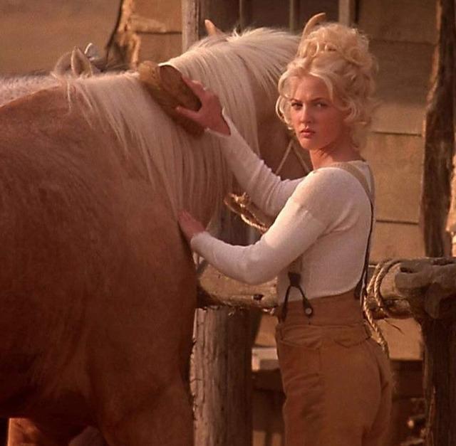 Lilly Laronette tending to her horse, showing the softer side of a determined gunslinger.