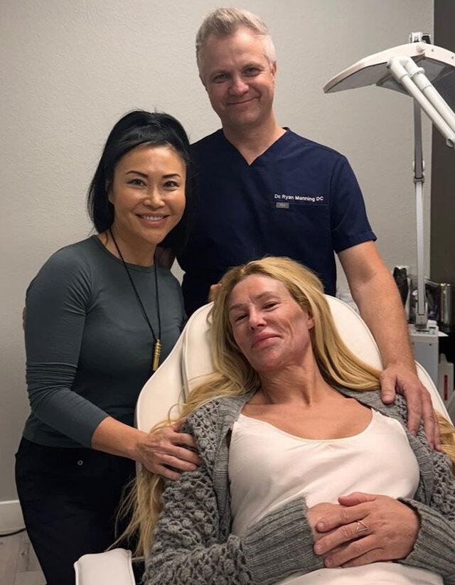 Supported at last: Brandi pictured with medical professionals who helped her through the toughest stages of recovery.