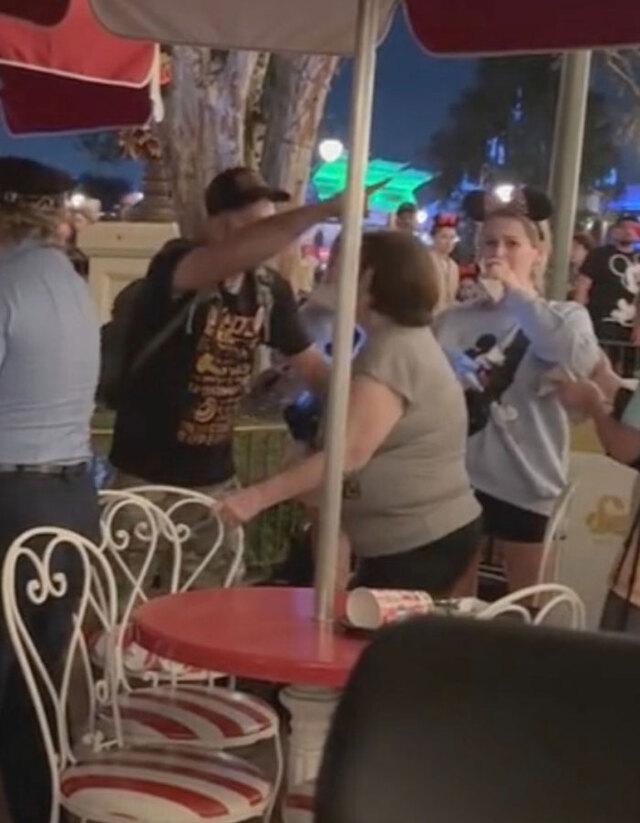 Tense moment as a young man strikes a woman at the outdoor dining area.