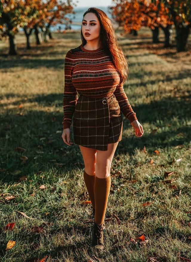 Through golden fields, she moves like a muse rooted in both strength and serenity.