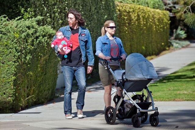 Emily Procter enjoying family life with partner Paul Bryan and their daughter, a candid moment of love and joy.
