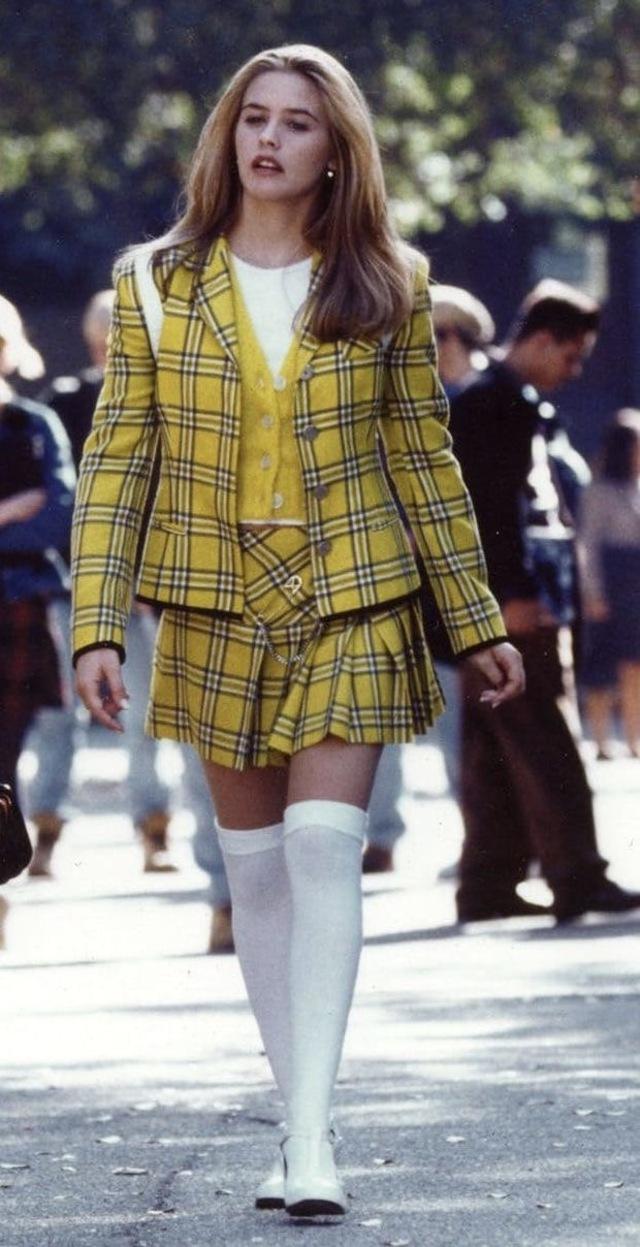Her yellow plaid suit, worn with utter confidence, represents not just a fashion statement but her evolving character arc.