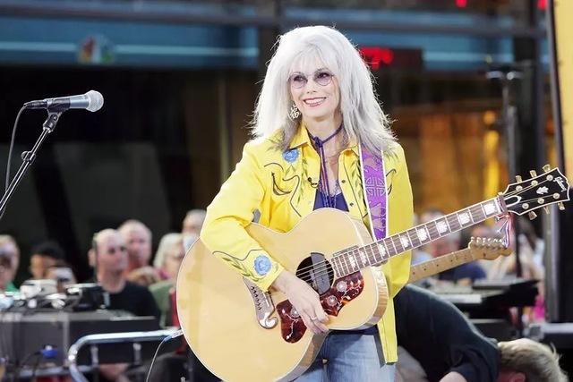 Emmylou Harris in action, dazzling the crowd with her powerful voice and energetic stage presence.