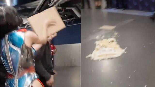 Katy, after blowing out the candles, picked up the cake and attempted to throw it at one of her staff members.