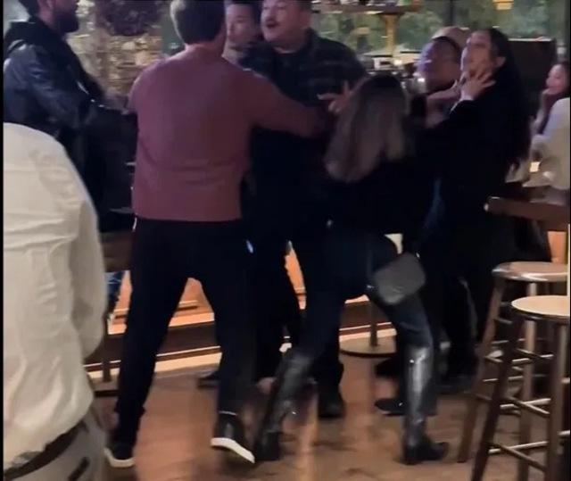 A chaotic scene unfolds as the altercation continues with multiple people getting involved.