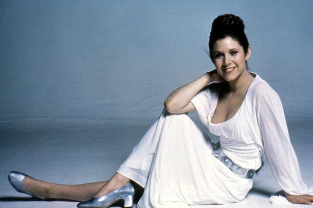 Carrie Fisher, captured in a serene moment from the 1970s, embodying youthful elegance.