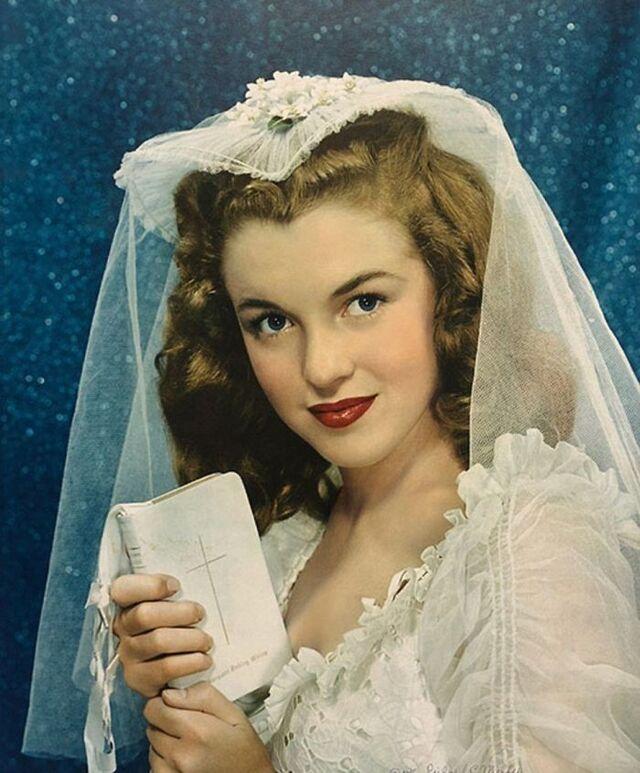 Norma Jeane in a delicate bridal portrait, wearing her first wedding dress—a rare early image capturing her innocence long before worldwide fame.