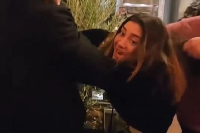 The intoxicated woman physically engages with restaurant staff, adding intensity to the conflict.