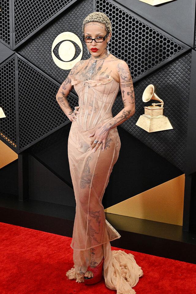 Doja Cat (2024) turned herself into a futuristic art installation by wearing a sheer gown over her own body art.