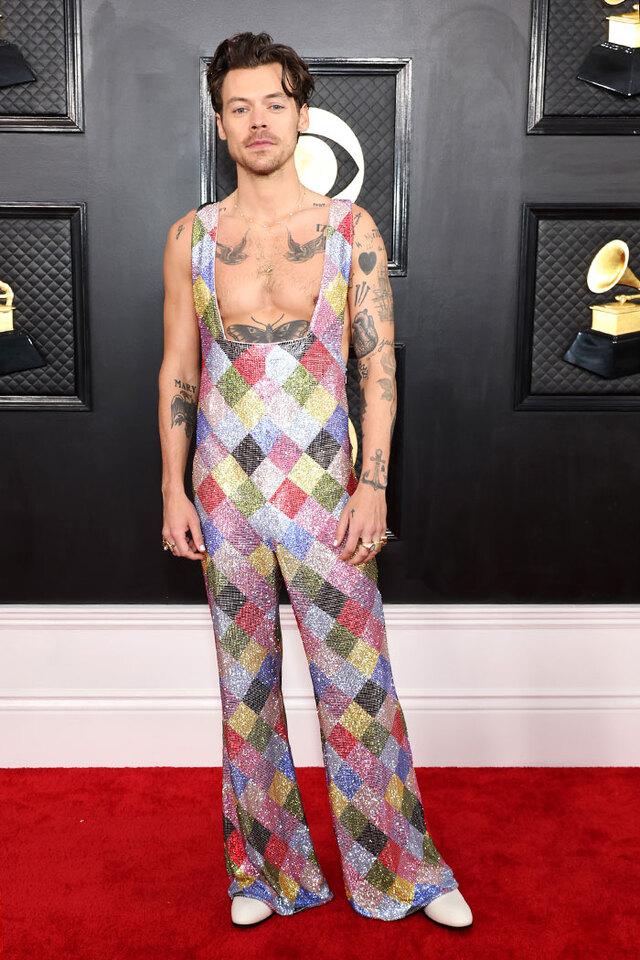 Harry Styles (2023) divided fans with a patchwork harlequin jumpsuit covered in a rainbow of Swarovski crystals.