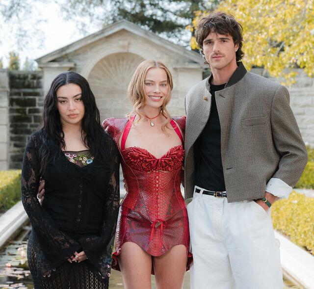 (Left to Right) Charli XCX joins Robbie and Elordi at the Wuthering Heights promotional event. 