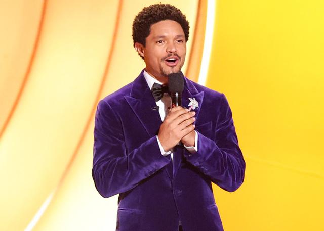 Trevor Noah, clad in a purple velvet jacket, engages the celebrity audience during the monologue that divided fans on social media.