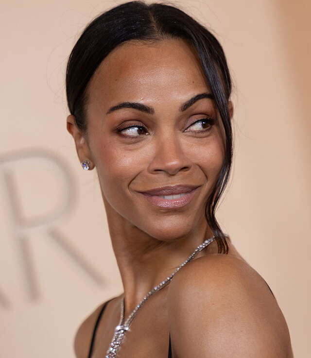 Zoe Saldaña showcasing a youthful complexion while displaying natural under-eye shadows.