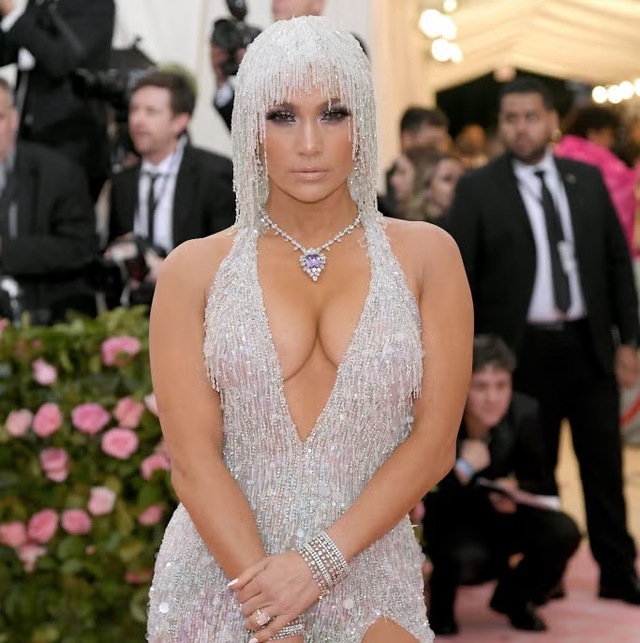 By the time she reached the 2019 Met Gala, covered in crystals and exuding a timeless, almost ethereal beauty, it became clear that JLo does not just follow fashion—she masters it