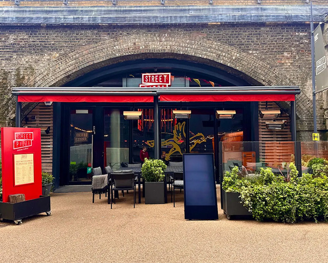 Gordon Ramsay’s Street Pizza in London, where an influencer's viral TikTok post regarding a pet training mat sparked a massive international debate on dining standards.