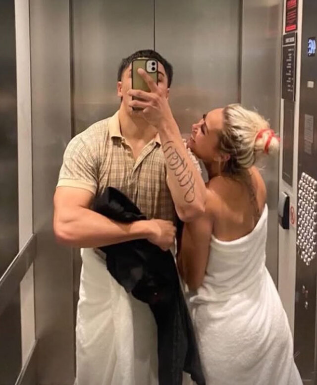 A mirror selfie of Lorenzo and Jessica together in an elevator, showcasing their close domestic attachment.