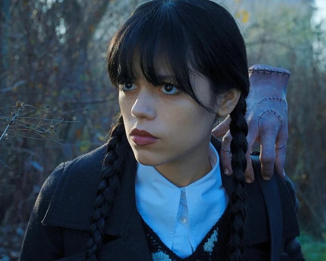 By minimizing product application and refusing to hide Ortega’s natural under-eye structures, McDonald allowed the character’s raw, internal moodiness to translate directly onto the screen.