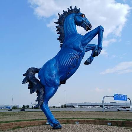 Meet "Blucifer", the 32' high fiberglass statue that killed his creator,  Luis Jiménez. Officially titled "Mustang", he stands just outside the Denver  Airport on a small patch of ground between 2 busy